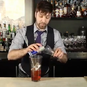 bartender mixing red bull cocktail