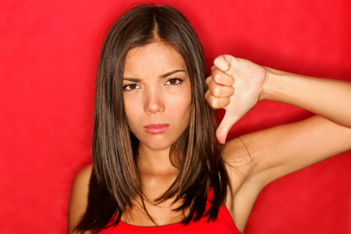 Unhappy thumbs down woman