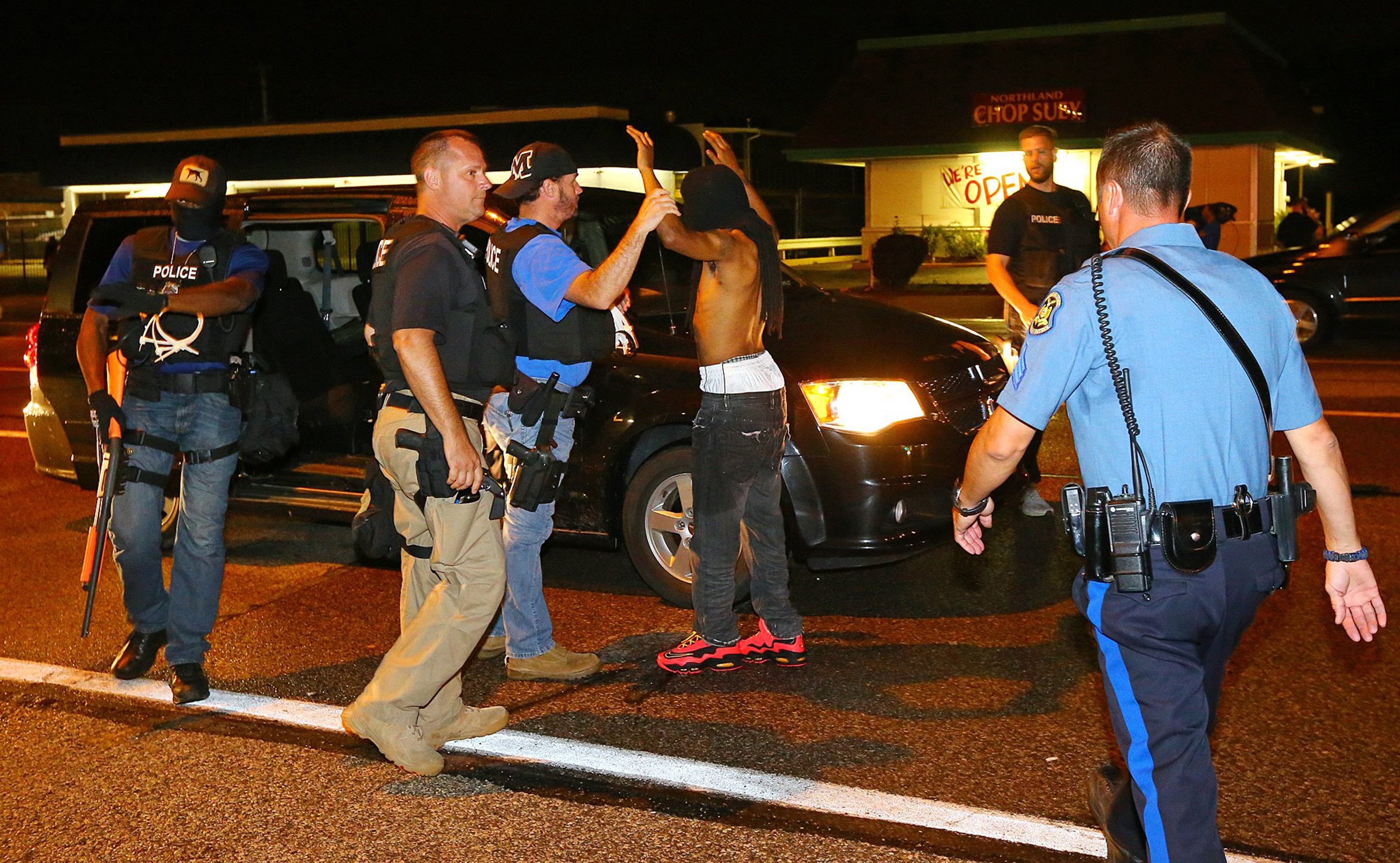 A protester is arrested while walking down the street on West Florissant Avenue on a relatively peaceful night on Wednesday, August 20, 2014, in Ferguson, Mo. (Curtis Compton/Atlanta Journal-Constitution/MCT)