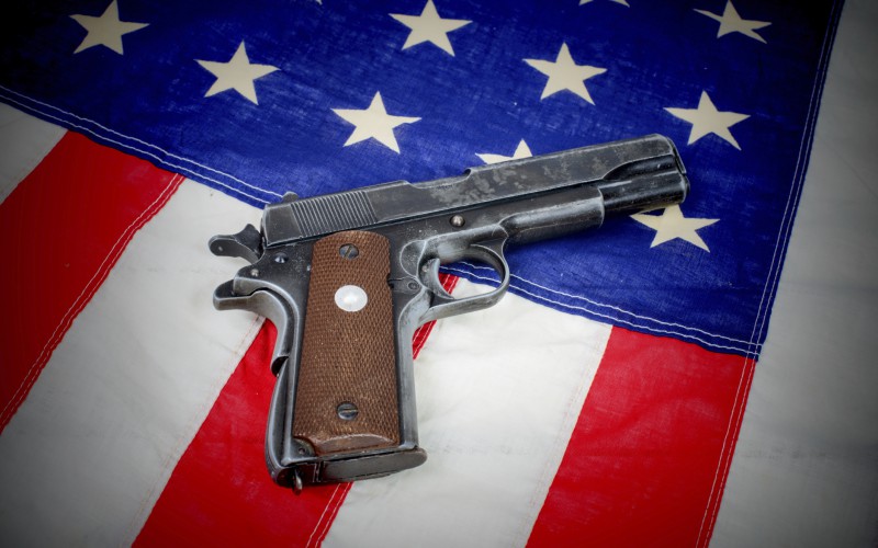 gun laid on the American flag