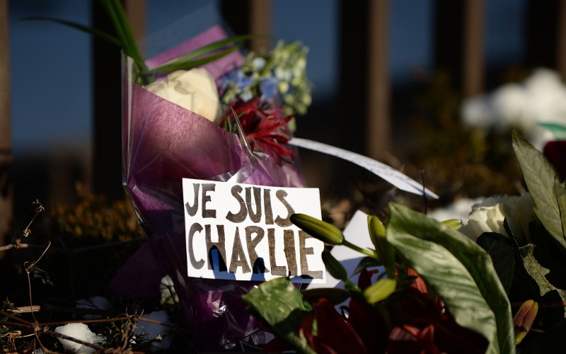 Flowers are left with notes written in French reading 'I am Charlie' and "rest in peace" near the fence at the French Embassy over a flower memorial January 8, 2015 in Washington, D.C., in response to the attack on satirical French magazine Charlie Hebdo by three gunmen yesterday that took the lives of 12 people. (Olivier Douliery/Abaca Press/TNS)