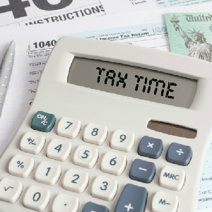 Tax Forms And Check With Calculator That Spells Out TAX TIME On The Display