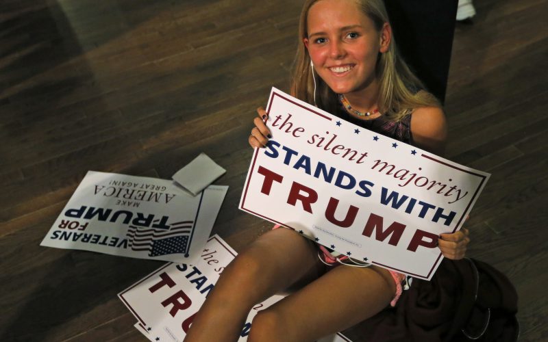 Young woman with Trump sign