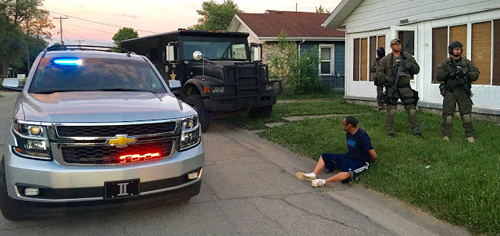 Man arrested sitting in grass
